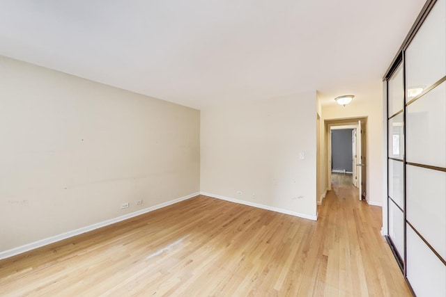 1415 W Lunt Ave Unit 203, Chicago, IL 60626 - spare room with light wood-style flooring, baseboards, and a baseboard heating unit