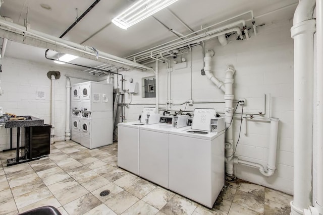1415 W Lunt Ave Unit 203, Chicago, IL 60626 - communal laundry room with stacked washer / drying machine, washing machine and clothes dryer, and concrete block wall