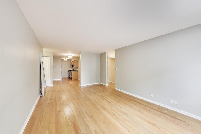 1415 W Lunt Ave Unit 203, Chicago, IL 60626 - unfurnished living room featuring light wood finished floors and baseboards