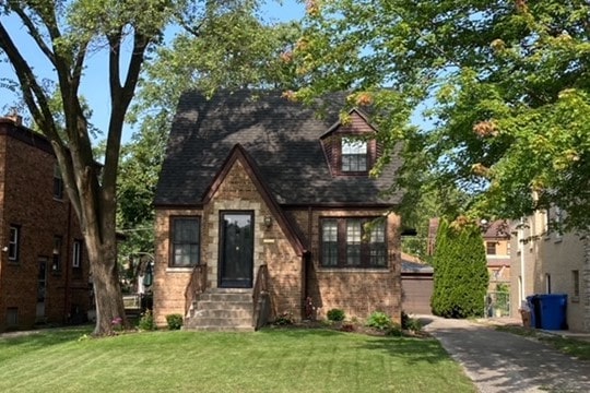 10752 S Washtenaw Ave, Chicago, IL 60655 - english style home featuring a front yard and stone siding