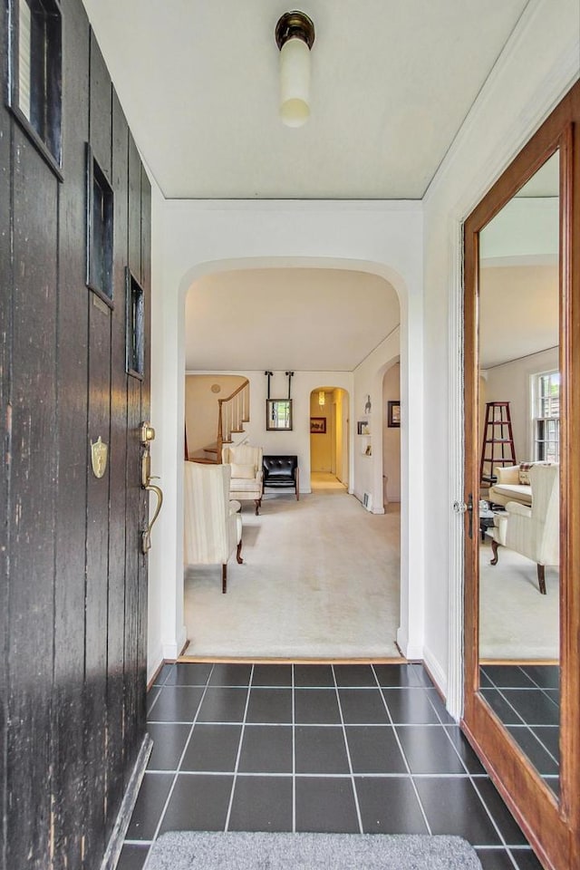 10752 S Washtenaw Ave, Chicago, IL 60655 - carpeted foyer entrance featuring arched walkways, tile patterned floors, stairway, and baseboards