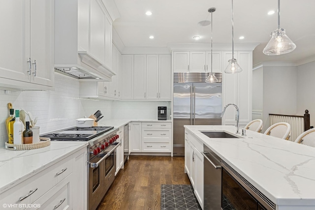 843 W Buckingham Pl Unit 1W, Chicago, IL 60657 - kitchen featuring premium appliances, custom range hood, a sink, dark wood-type flooring, and a center island with sink