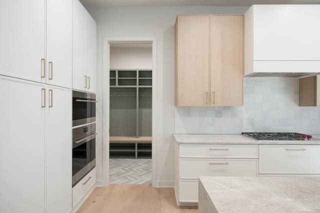8 Heritage Dr, Highland Park, IL 60035 - kitchen with light wood-style floors, tasteful backsplash, stainless steel gas stovetop, and light brown cabinets