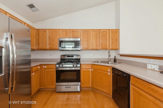 24149 W Pear Tree Cir Unit A, Plainfield, IL 60585 - kitchen with stainless steel appliances, vaulted ceiling, light wood-style floors, and light countertops