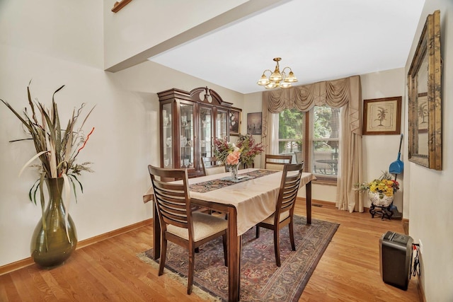 1072 Ronald Dr, Joliet, IL 60435 - dining room with a chandelier, light wood-style floors, and baseboards