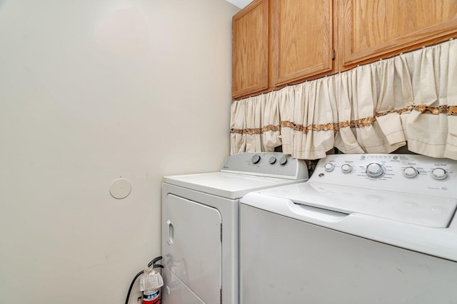 1072 Ronald Dr, Joliet, IL 60435 - laundry room with cabinet space and independent washer and dryer