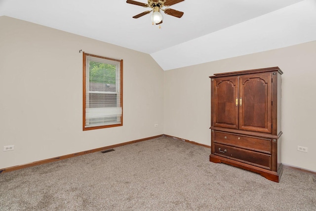 1072 Ronald Dr, Joliet, IL 60435 - unfurnished bedroom with light carpet, baseboards, lofted ceiling, and a ceiling fan