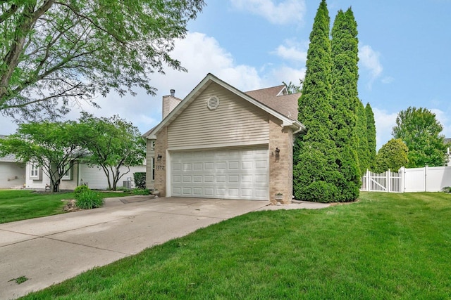 1072 Ronald Dr, Joliet, IL 60435 - view of home's exterior with a chimney, concrete driveway, an attached garage, and a gate