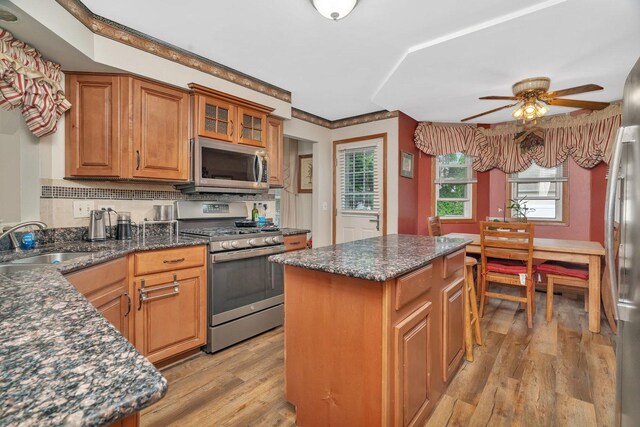 1072 Ronald Dr, Joliet, IL 60435 - kitchen featuring stainless steel appliances, a sink, light wood-style floors, a ceiling fan, and brown cabinetry