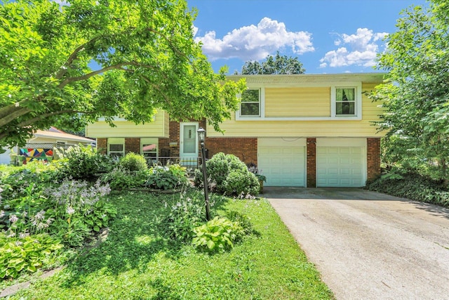 309 E Mchenry St, Urbana, IL 61801 - bi-level home with brick siding, an attached garage, and driveway
