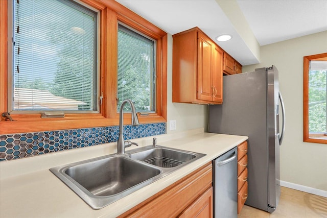 309 E Mchenry St, Urbana, IL 61801 - kitchen featuring stainless steel appliances, light countertops, recessed lighting, and brown cabinets