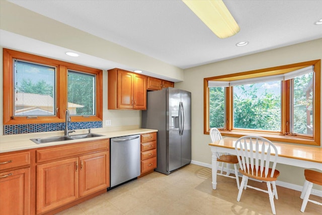 309 E Mchenry St, Urbana, IL 61801 - kitchen featuring appliances with stainless steel finishes, light countertops, recessed lighting, and brown cabinets