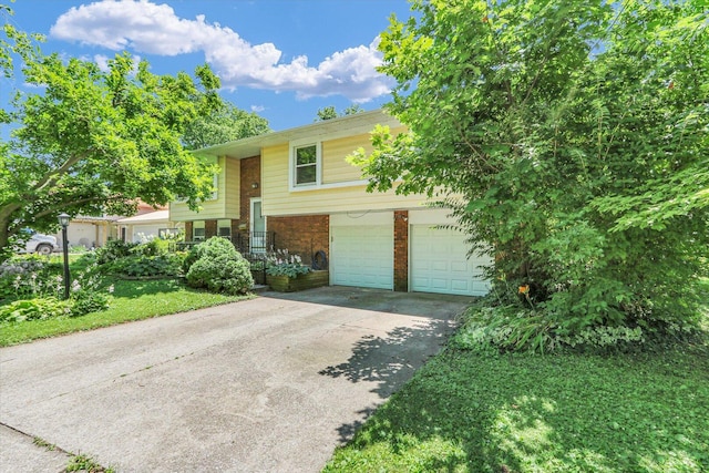 309 E Mchenry St, Urbana, IL 61801 - bi-level home featuring an attached garage, driveway, and brick siding
