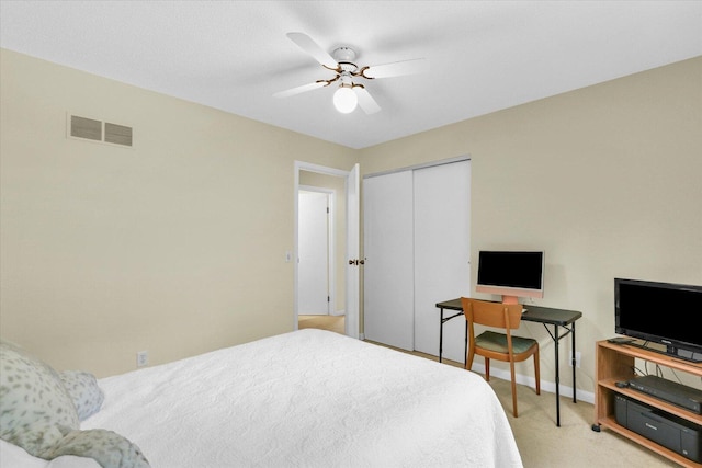 309 E Mchenry St, Urbana, IL 61801 - bedroom featuring light carpet, a closet, and a ceiling fan