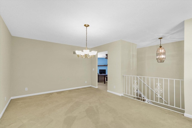 309 E Mchenry St, Urbana, IL 61801 - spare room with a chandelier and light colored carpet