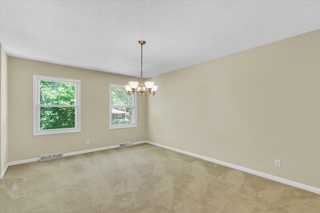 309 E Mchenry St, Urbana, IL 61801 - unfurnished room with carpet and a chandelier