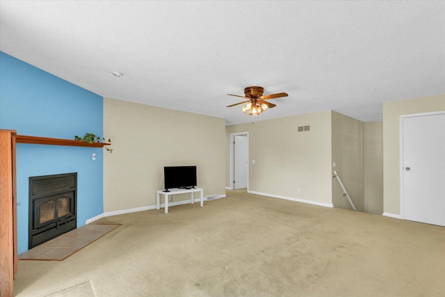 309 E Mchenry St, Urbana, IL 61801 - unfurnished living room with carpet floors, a fireplace, and a ceiling fan