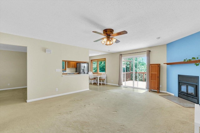 309 E Mchenry St, Urbana, IL 61801 - living room featuring a ceiling fan, light colored carpet, and a textured ceiling
