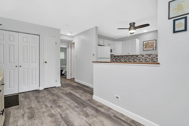 1118 Cedar St Unit 1B, Glendale Heights, IL 60139 - unfurnished living room featuring a ceiling fan, wood finished floors, baseboards, and recessed lighting