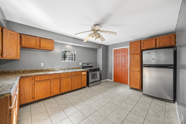 6812 S Lafayette Ave, Chicago, IL 60621 - kitchen with appliances with stainless steel finishes, a ceiling fan, brown cabinets, and light tile patterned flooring