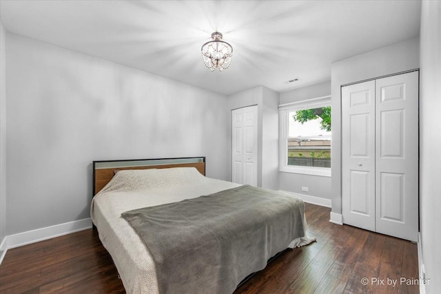 2800 Northampton Dr Unit A2, Rolling Meadows, IL 60008 - bedroom with two closets, wood finished floors, baseboards, and a chandelier
