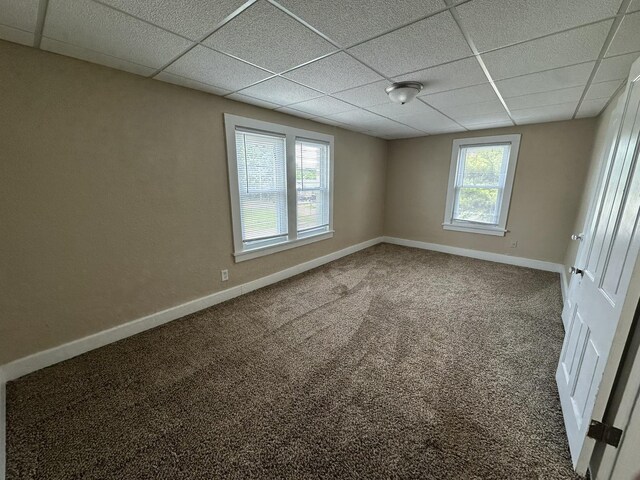 1109 S Locust Ave, Freeport, IL 61032 - spare room featuring a drop ceiling, baseboards, and carpet flooring