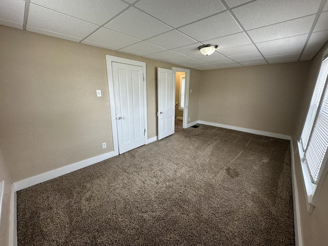 1109 S Locust Ave, Freeport, IL 61032 - unfurnished bedroom featuring a drop ceiling, carpet, baseboards, and a closet