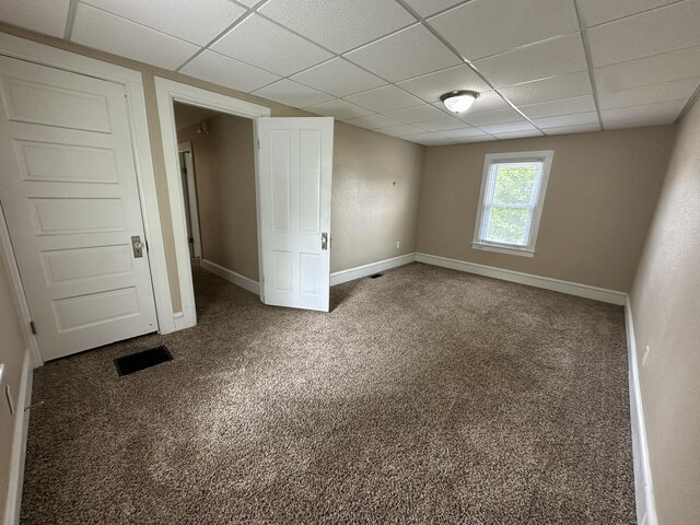 1109 S Locust Ave, Freeport, IL 61032 - unfurnished bedroom featuring a paneled ceiling, carpet floors, and baseboards