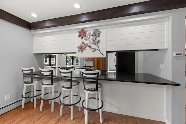 5760 Woodward Ave, Downers Grove, IL 60516 - kitchen featuring freestanding refrigerator, wood finished floors, a peninsula, recessed lighting, and dark countertops