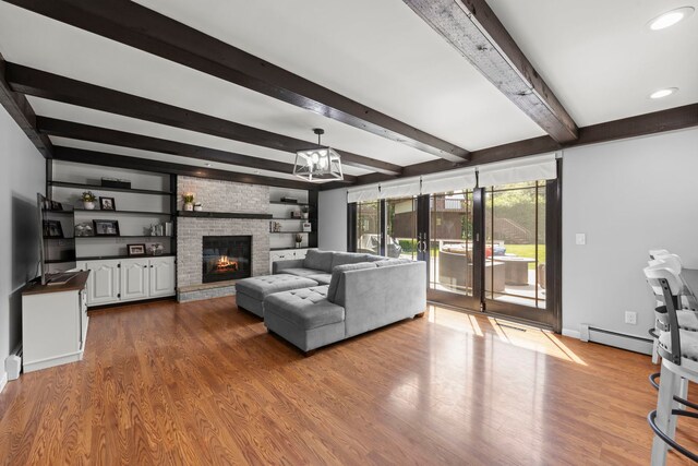 5760 Woodward Ave, Downers Grove, IL 60516 - living area with a baseboard radiator, wood finished floors, beamed ceiling, a brick fireplace, and recessed lighting