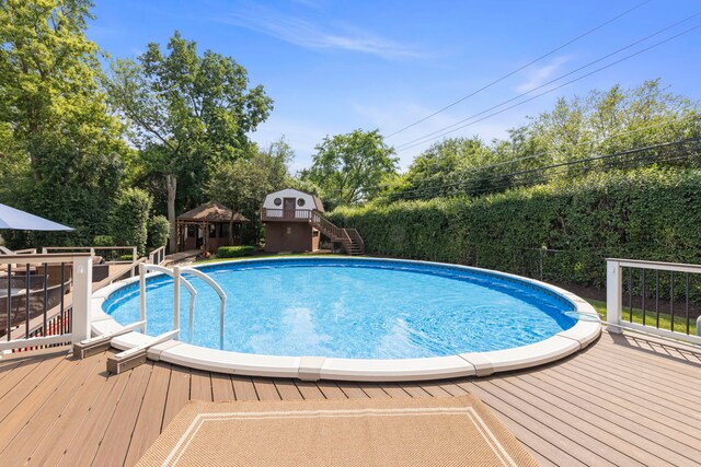 5760 Woodward Ave, Downers Grove, IL 60516 - view of swimming pool featuring a deck, stairs, and view of wooded area