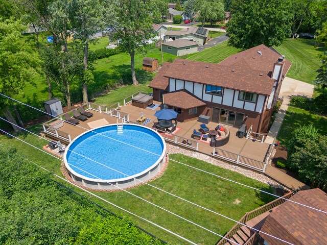 5760 Woodward Ave, Downers Grove, IL 60516 - view of pool featuring a wooden deck, a fenced backyard, a grill, an outdoor living space, and an outdoor structure