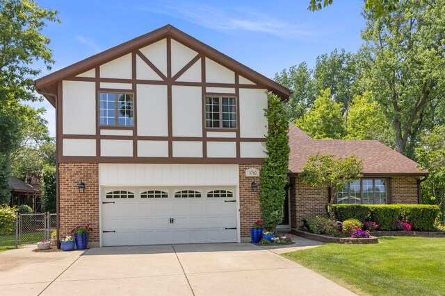 5760 Woodward Ave, Downers Grove, IL 60516 - tudor home with brick siding, concrete driveway, a garage, and roof with shingles