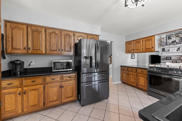5760 Woodward Ave, Downers Grove, IL 60516 - kitchen featuring appliances with stainless steel finishes, brown cabinetry, light tile patterned floors, and dark countertops