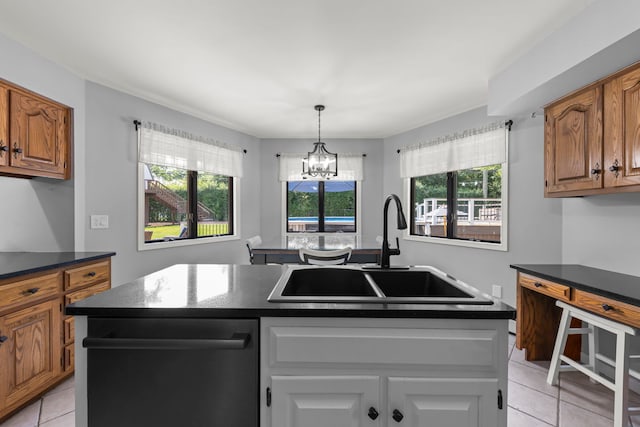 5760 Woodward Ave, Downers Grove, IL 60516 - kitchen featuring stainless steel dishwasher, light tile patterned floors, a chandelier, and healthy amount of natural light