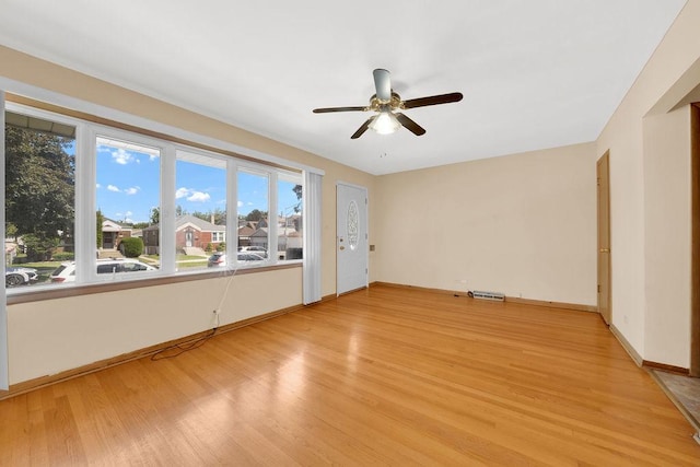 5438 S Hamlin Ave, Chicago, IL 60632 - spare room featuring light wood finished floors, a ceiling fan, healthy amount of natural light, and baseboards