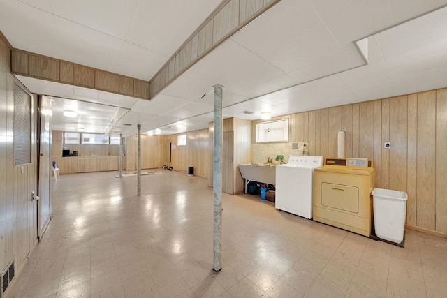 5438 S Hamlin Ave, Chicago, IL 60632 - below grade area featuring washing machine and clothes dryer, wood walls, and light floors