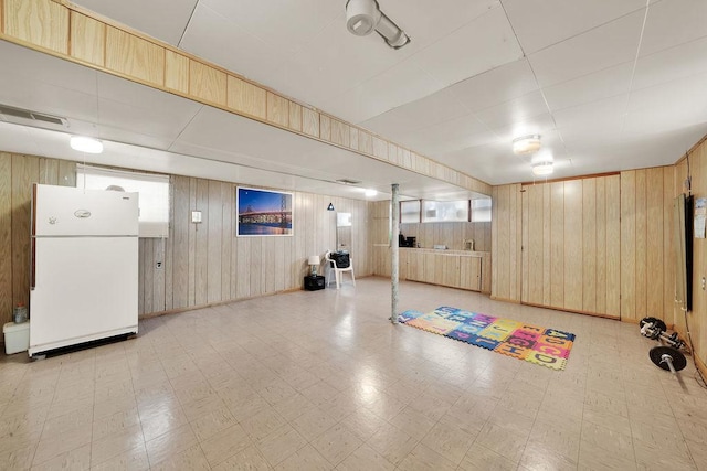 5438 S Hamlin Ave, Chicago, IL 60632 - below grade area with freestanding refrigerator, wooden walls, and light floors