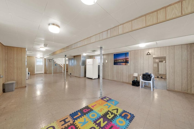 5438 S Hamlin Ave, Chicago, IL 60632 - basement with freestanding refrigerator, tile patterned floors, and wood walls