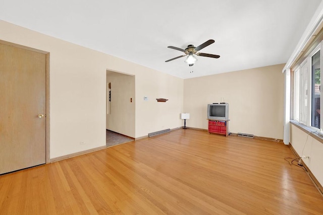 5438 S Hamlin Ave, Chicago, IL 60632 - unfurnished living room with light wood-style floors, ceiling fan, and baseboards