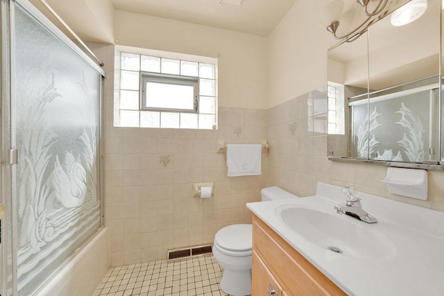 5438 S Hamlin Ave, Chicago, IL 60632 - bathroom featuring tile walls, toilet, vanity, enclosed tub / shower combo, and tile patterned flooring