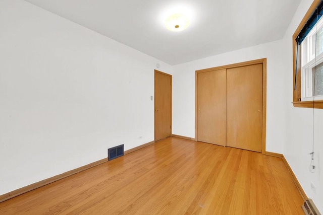 5438 S Hamlin Ave, Chicago, IL 60632 - unfurnished bedroom featuring light wood finished floors, baseboards, and a closet
