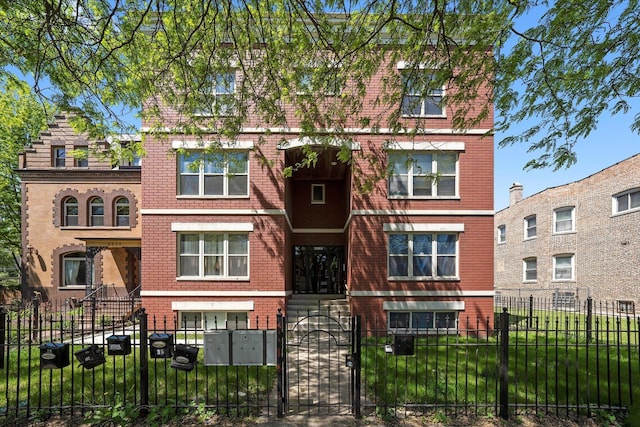 6528 S University Ave Unit 3N, Chicago, IL 60615 - view of front of home with brick siding, a fenced front yard, and a gate