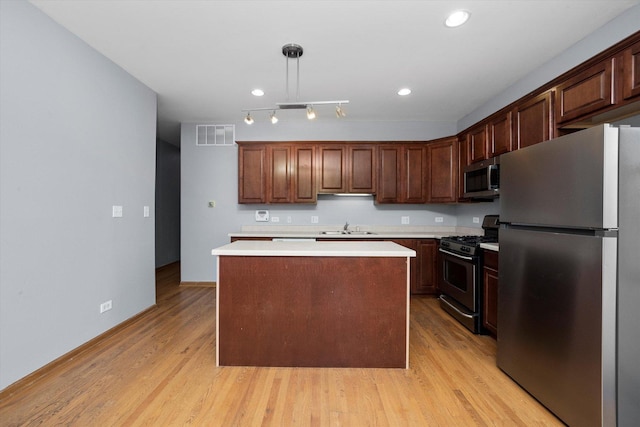 6528 S University Ave Unit 3N, Chicago, IL 60615 - kitchen with stainless steel appliances, a sink, light countertops, light wood-style floors, and recessed lighting