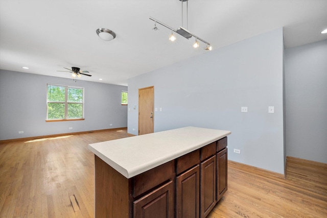 6528 S University Ave Unit 3N, Chicago, IL 60615 - kitchen with ceiling fan, light wood finished floors, light countertops, a kitchen island, and recessed lighting