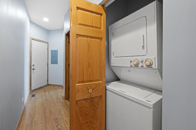 6528 S University Ave Unit 3N, Chicago, IL 60615 - washroom with stacked washer and clothes dryer, electric panel, light wood finished floors, and baseboards