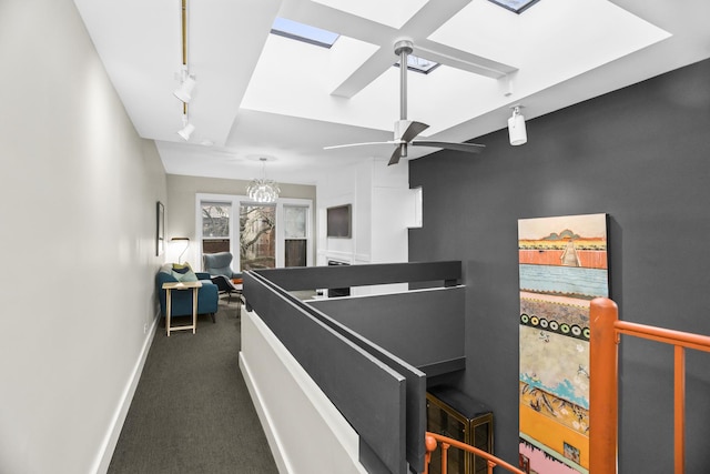913 Michigan Ave Unit 3, Evanston, IL 60202 - hallway with a skylight, an upstairs landing, dark carpet, and track lighting