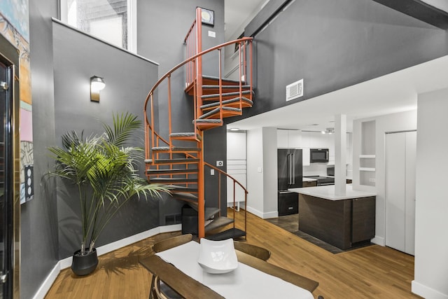 913 Michigan Ave Unit 3, Evanston, IL 60202 - living area featuring a towering ceiling, wood finished floors, baseboards, and stairs