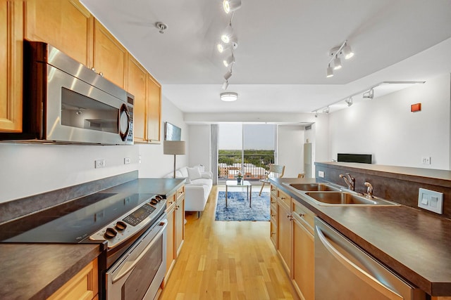 1640 Maple Ave Unit 1105, Evanston, IL 60201 - kitchen with appliances with stainless steel finishes, open floor plan, a sink, and dark countertops