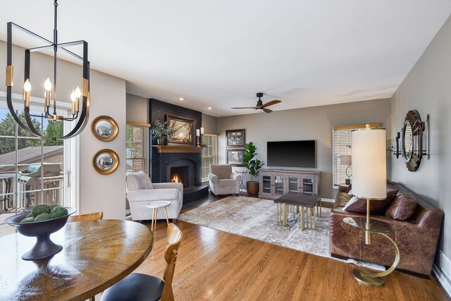 1N183 Stacy Ct, Glen Ellyn, IL 60137 - living room with a large fireplace, wood finished floors, plenty of natural light, a chandelier, and recessed lighting